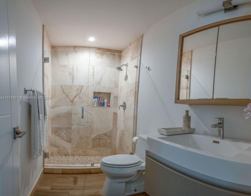 452 Woodcrest Road Key Biscayne, FL 33149 - Photo 16 of 23 a bathroom with a sink toilet and shower
