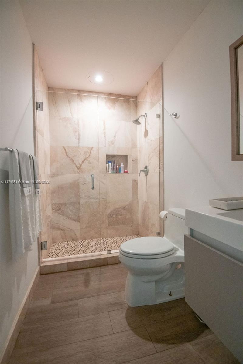 452 Woodcrest Road Key Biscayne, FL 33149 - Photo 17 of 23 a bathroom with a toilet a sink and shower
