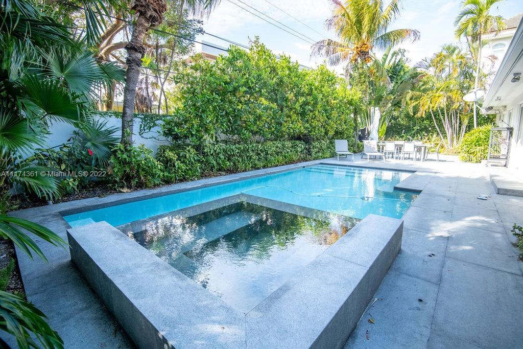 452 Woodcrest Road Key Biscayne, FL 33149 - Photo 21 of 23 a view of a swimming pool with a yard