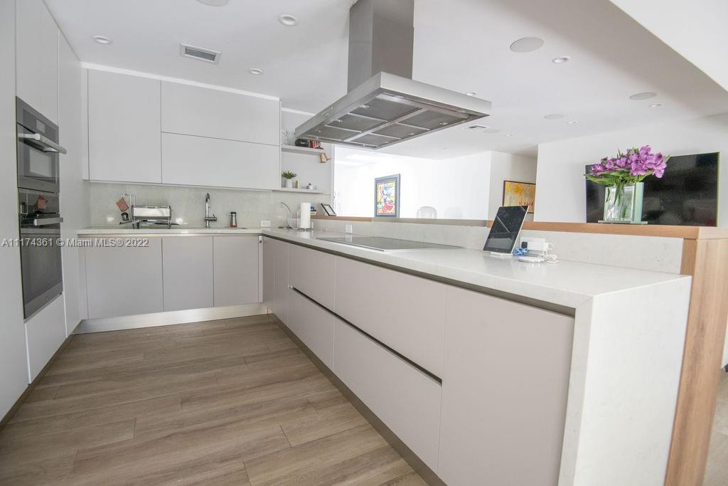 452 Woodcrest Road Key Biscayne, FL 33149 - Photo 5 of 23 a kitchen with sink cabinets and wooden floor