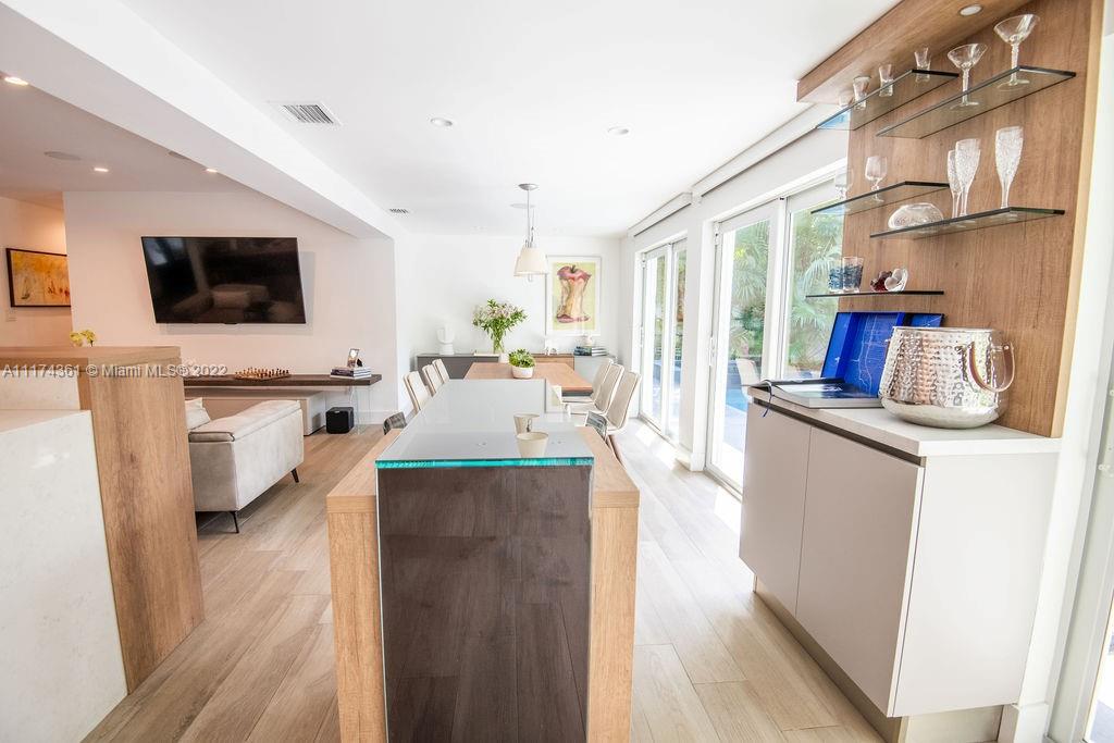 452 Woodcrest Road Key Biscayne, FL 33149 - Photo 7 of 23 a kitchen with stainless steel appliances a stove top oven a sink a dining table and chairs