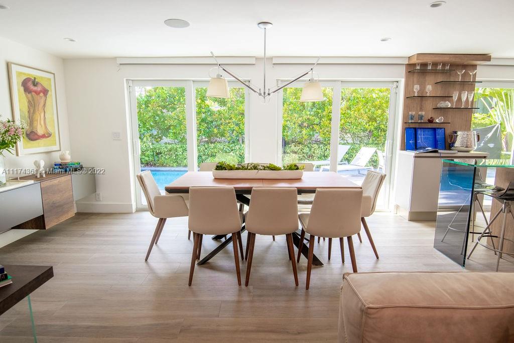452 Woodcrest Road Key Biscayne, FL 33149 - Photo 8 of 23 a dining room with furniture a chandelier and wooden floor
