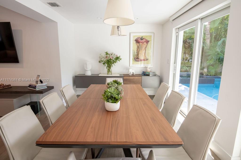 452 Woodcrest Road Key Biscayne, FL 33149 - Photo 9 of 23 a view of a dining room with furniture window and wooden floor