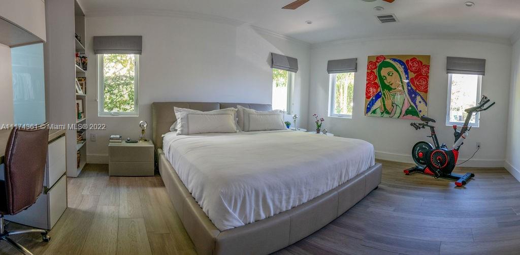 452 Woodcrest Road Key Biscayne, FL 33149 - Photo 10 of 23 a bedroom with a bed and a painting on the wall
