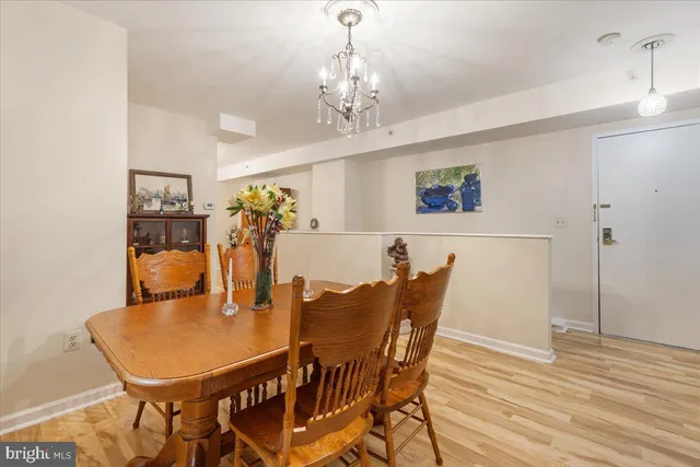 a view of a dining room with furniture and chandelier
