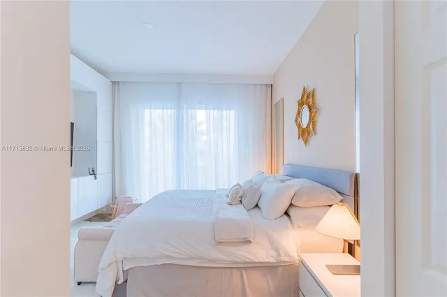 a bedroom with a bed and painting on the wall