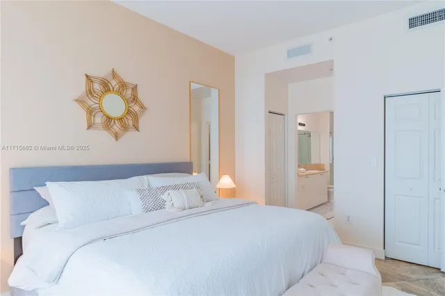 a bedroom with a bed and a painting on the wall