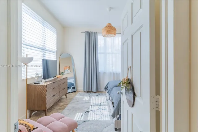 a bedroom with furniture and a wooden floor