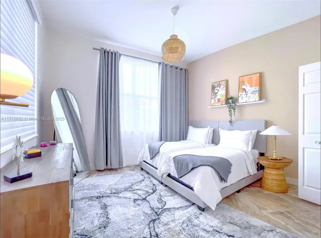 a bedroom with a bed and a large window