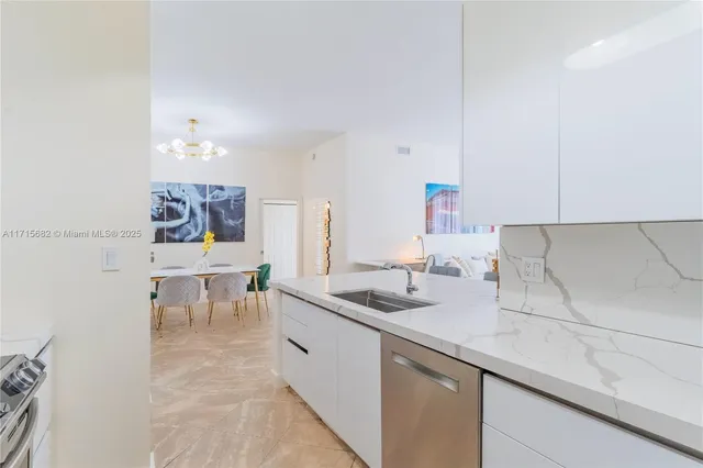 a kitchen with a sink and chairs