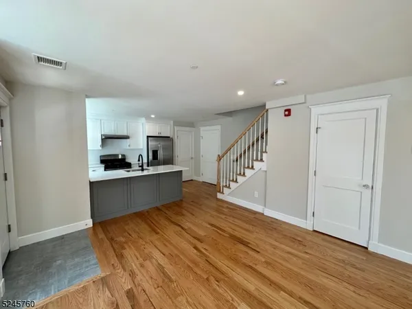 a view of kitchen with sink and wooden floor