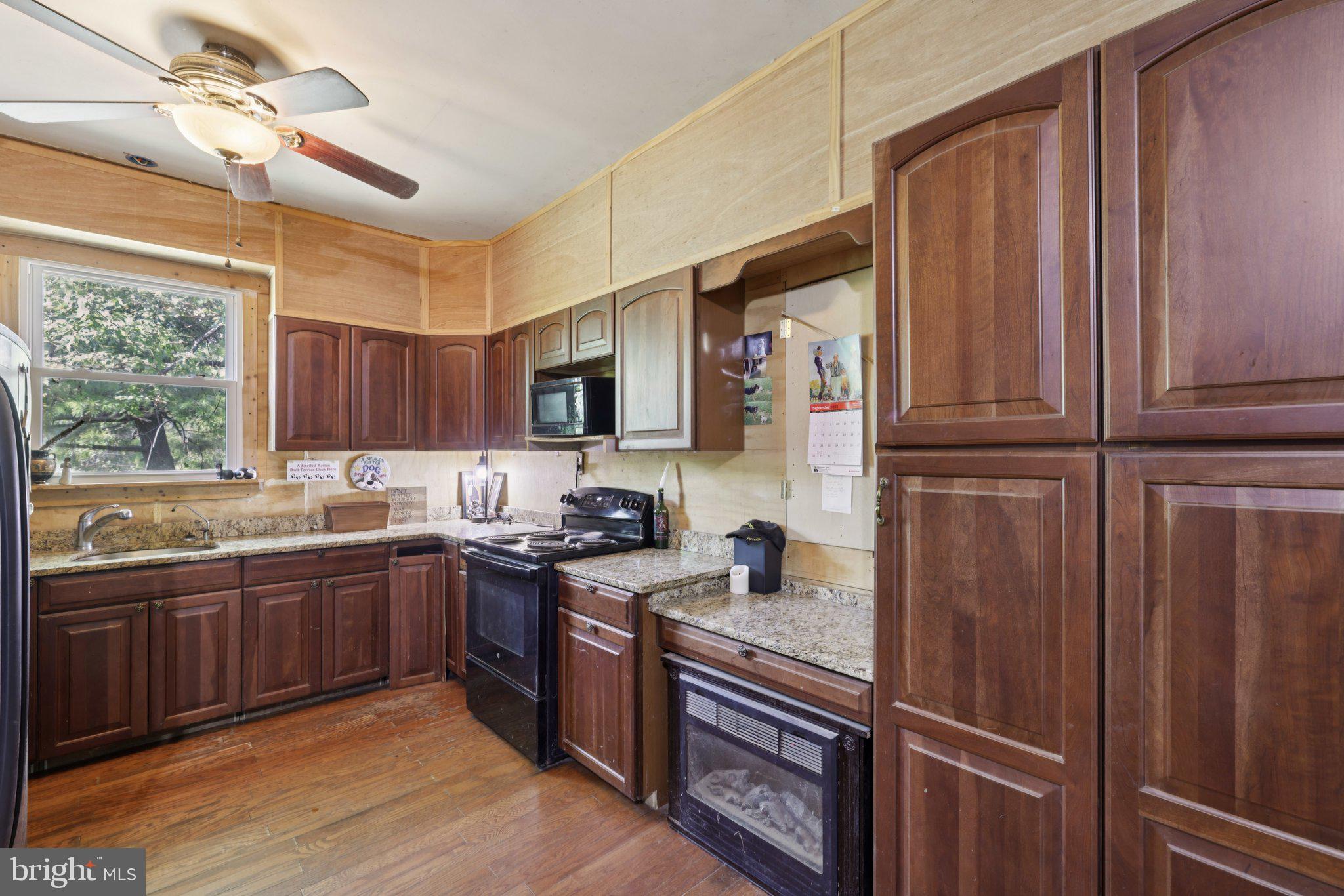 2636 Marston Road New Windsor, MD 21776 - Photo 51 of 107 a kitchen with stainless steel appliances granite countertop wooden cabinets a sink a stove a refrigerator and cabinetry