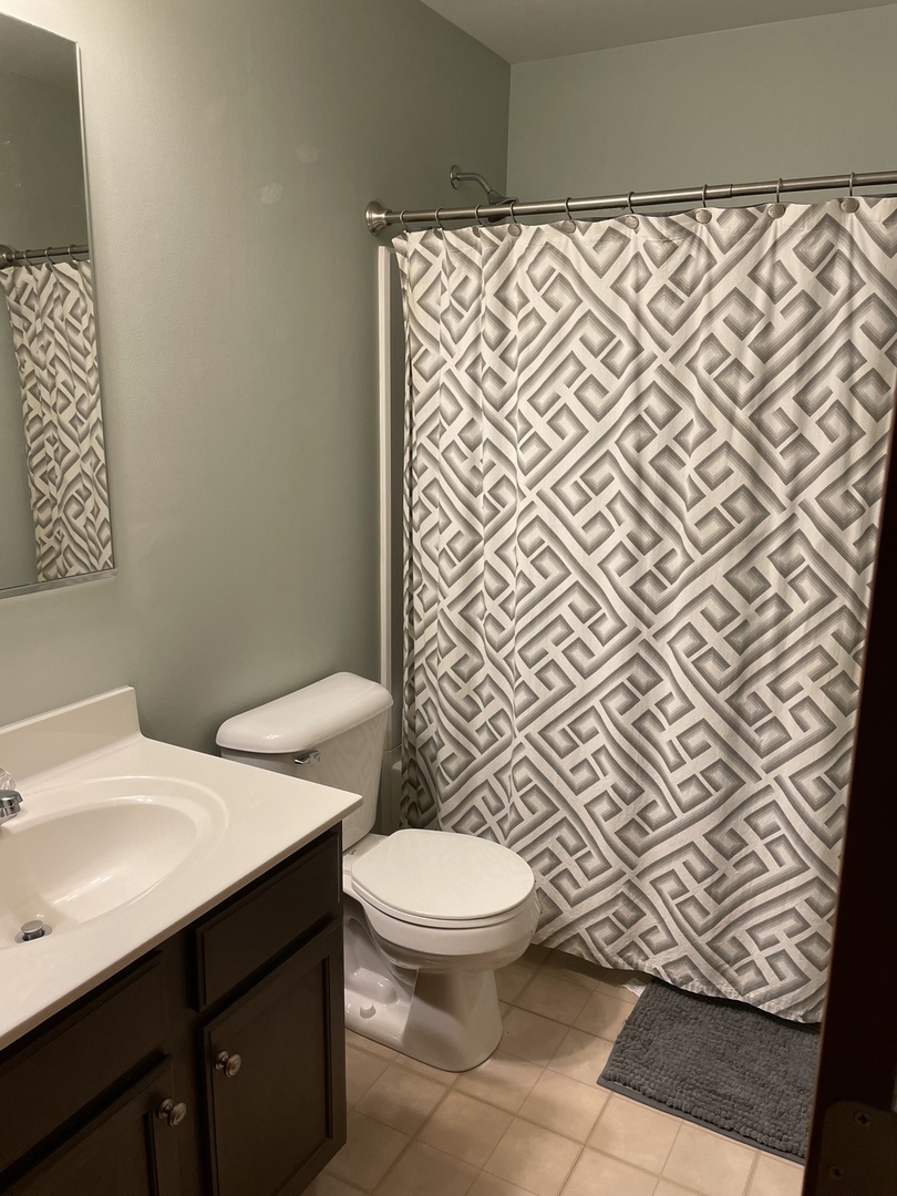 1841 Butterfield Road Woodstock, IL 60098 - Photo 16 of 26 a bathroom with a sink and a toilet