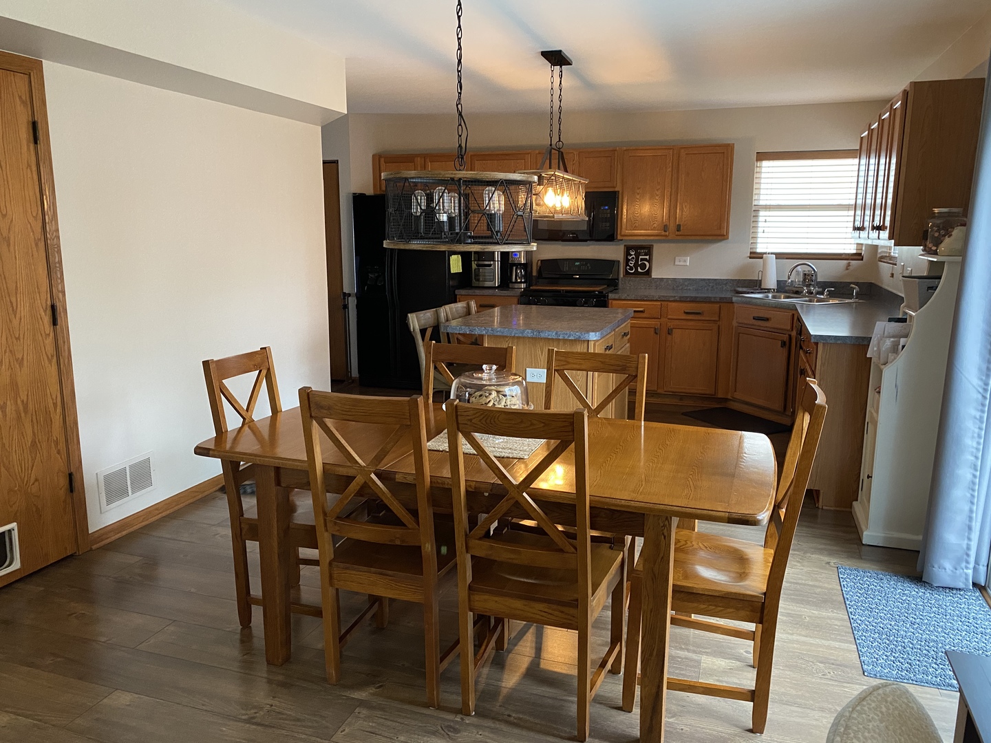 1841 Butterfield Road Woodstock, IL 60098 - Photo 10 of 26 a view of a dining room with furniture window and wooden floor