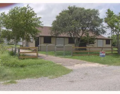 a view of backyard of house and trees