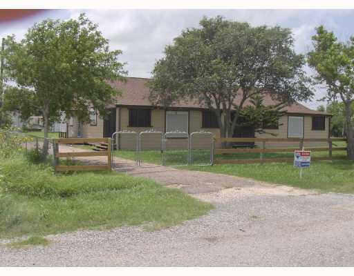 a view of backyard of house and trees