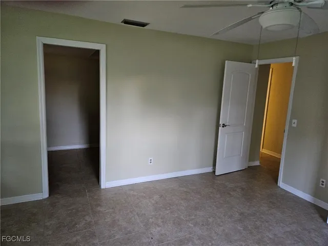 an empty room with a fan