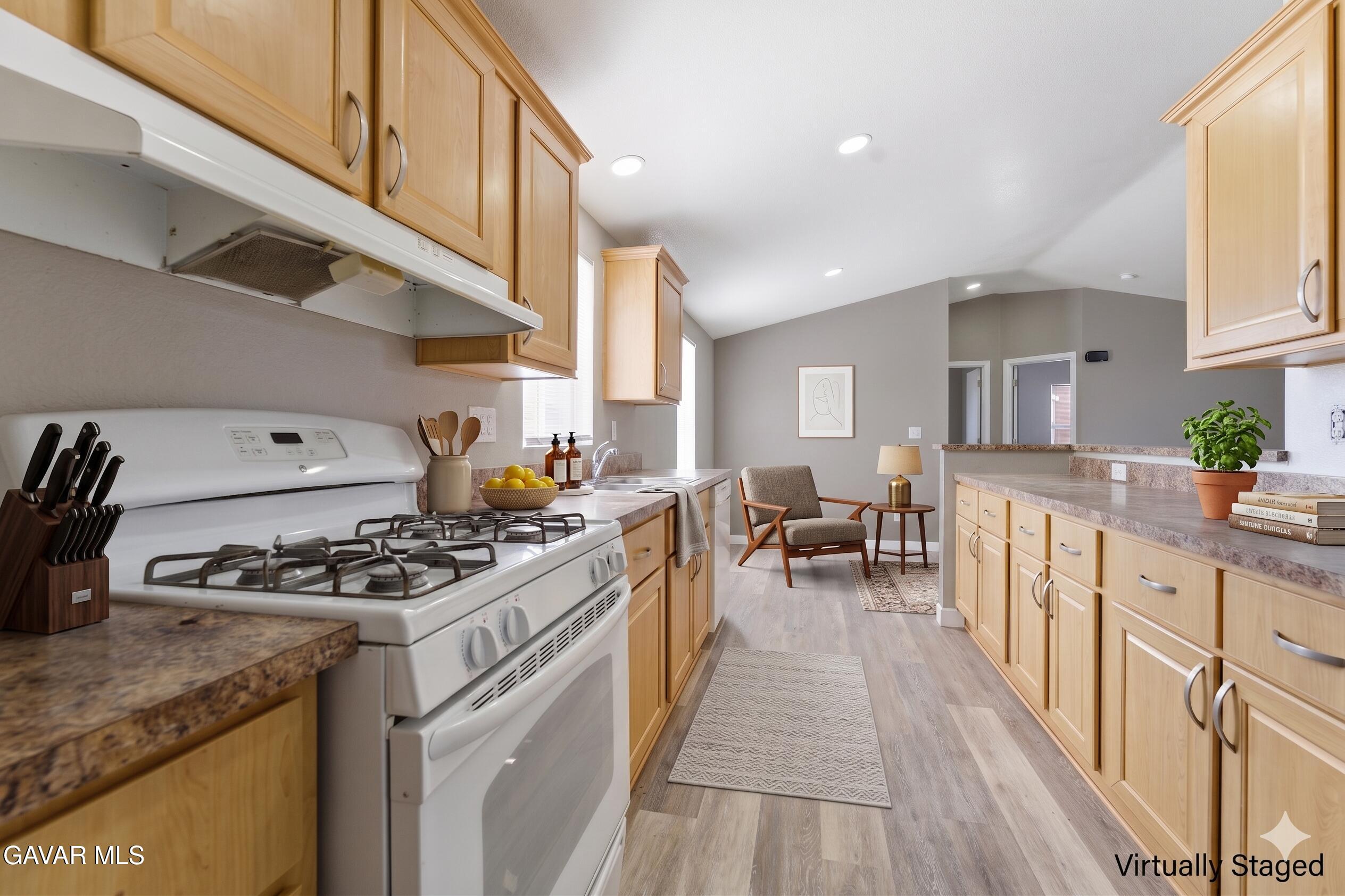 20843 Waalew Road Apple Valley, CA 92307 - Photo 7 of 40 a kitchen with stainless steel appliances granite countertop a stove a sink dishwasher and cabinets with wooden floor