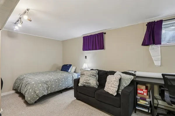 a bedroom with a bed and a couch