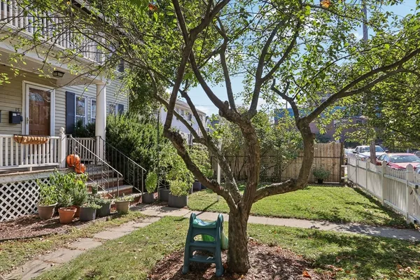 a view of a house with a tree in the yard