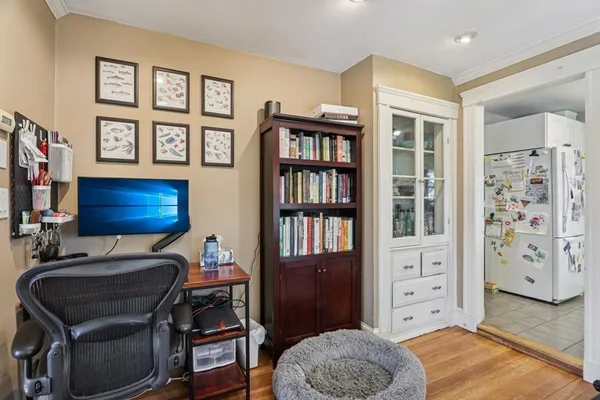 a kitchen with a sink a stove and white cabinets