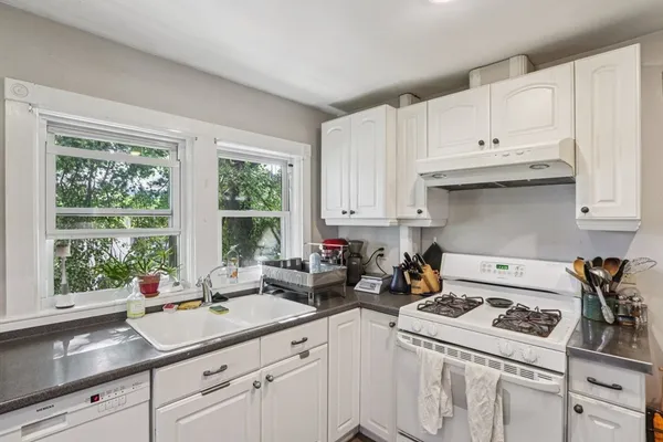 a kitchen with a sink stove and cabinets