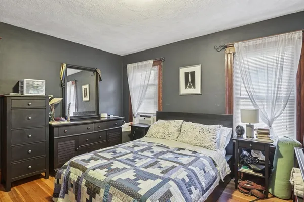 a bedroom with a bed and a book shelf