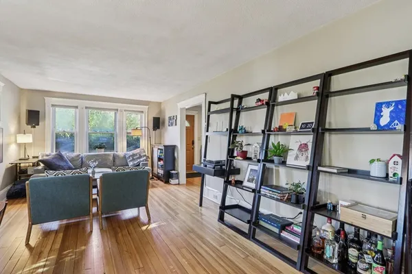 a living room with furniture and a floor to ceiling window