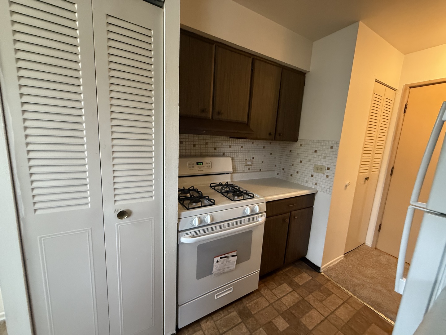 3001 Thatcher Avenue, Unit 5D River Grove, IL 60171 - Photo 10 of 11 a kitchen with a stove and a microwave
