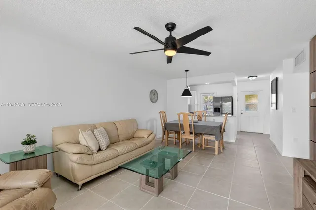 a living room with furniture and a ceiling fan