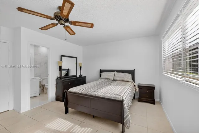 a bedroom with a bed and ceiling fan