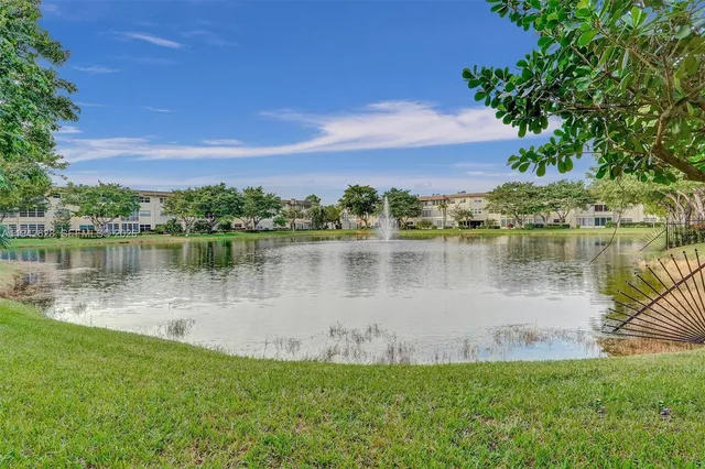 a view of a lake with houses in the back