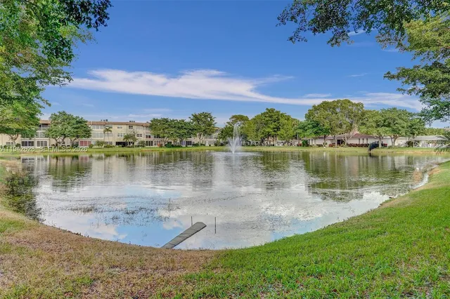 a view of a lake with houses in the back