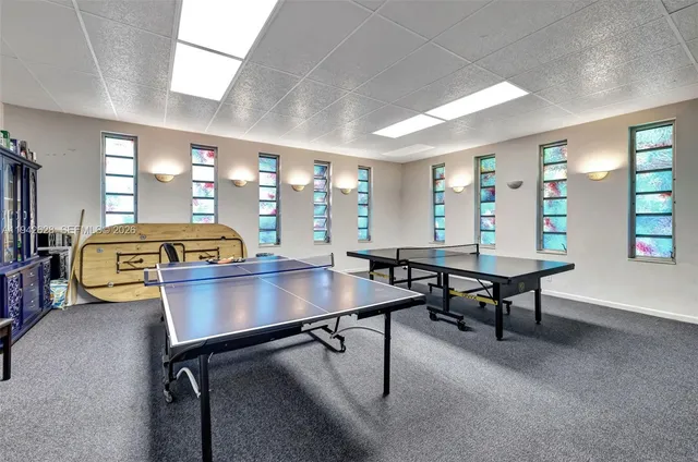 a view of a workspace with furniture and window