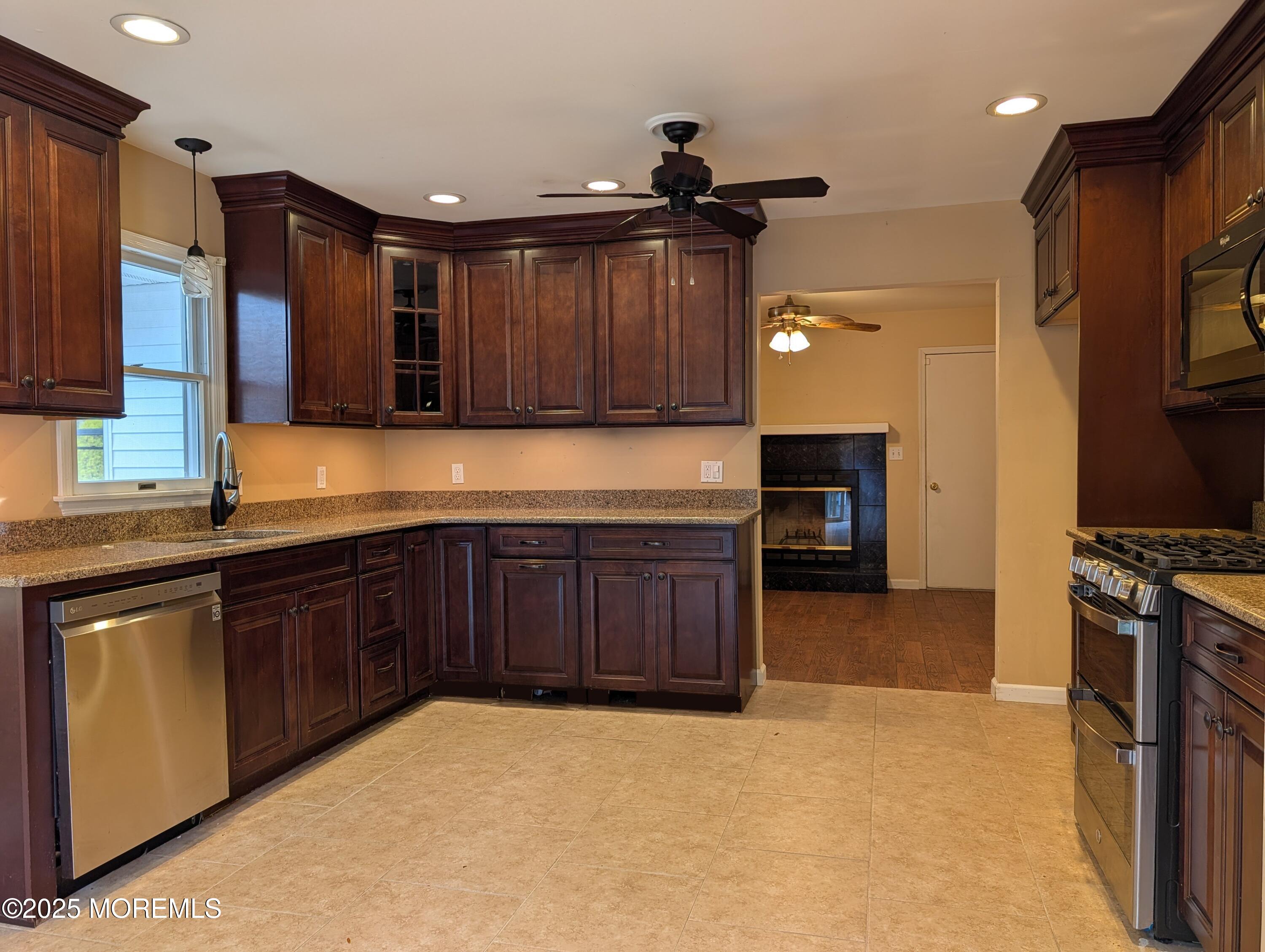 318 Eleanor Road Forked River, NJ 08731 - Photo 11 of 13 a kitchen with stainless steel appliances granite countertop a stove top oven a sink and a refrigerator