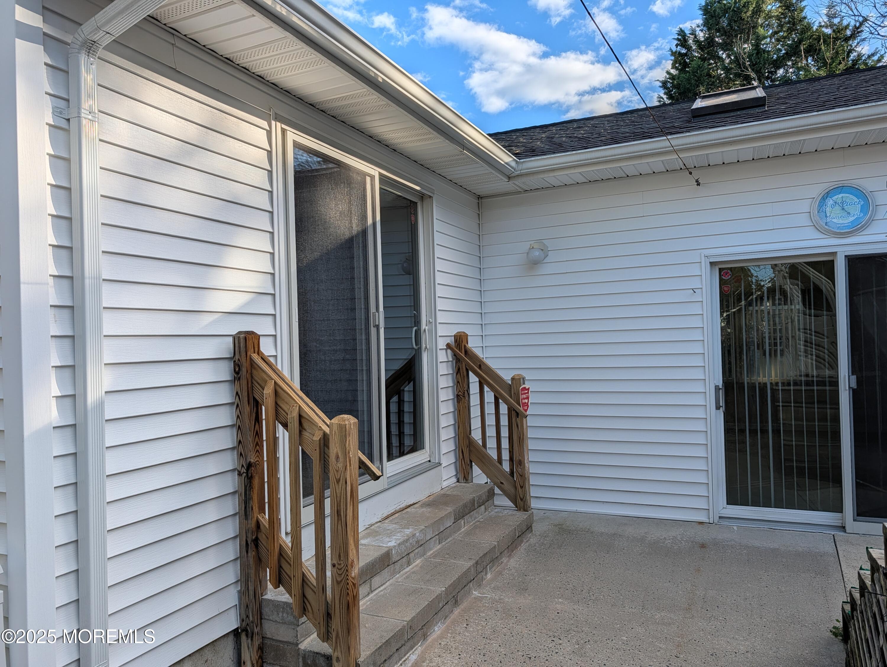 318 Eleanor Road Forked River, NJ 08731 - Photo 5 of 13 a view of a house with wooden stairs and a large tree
