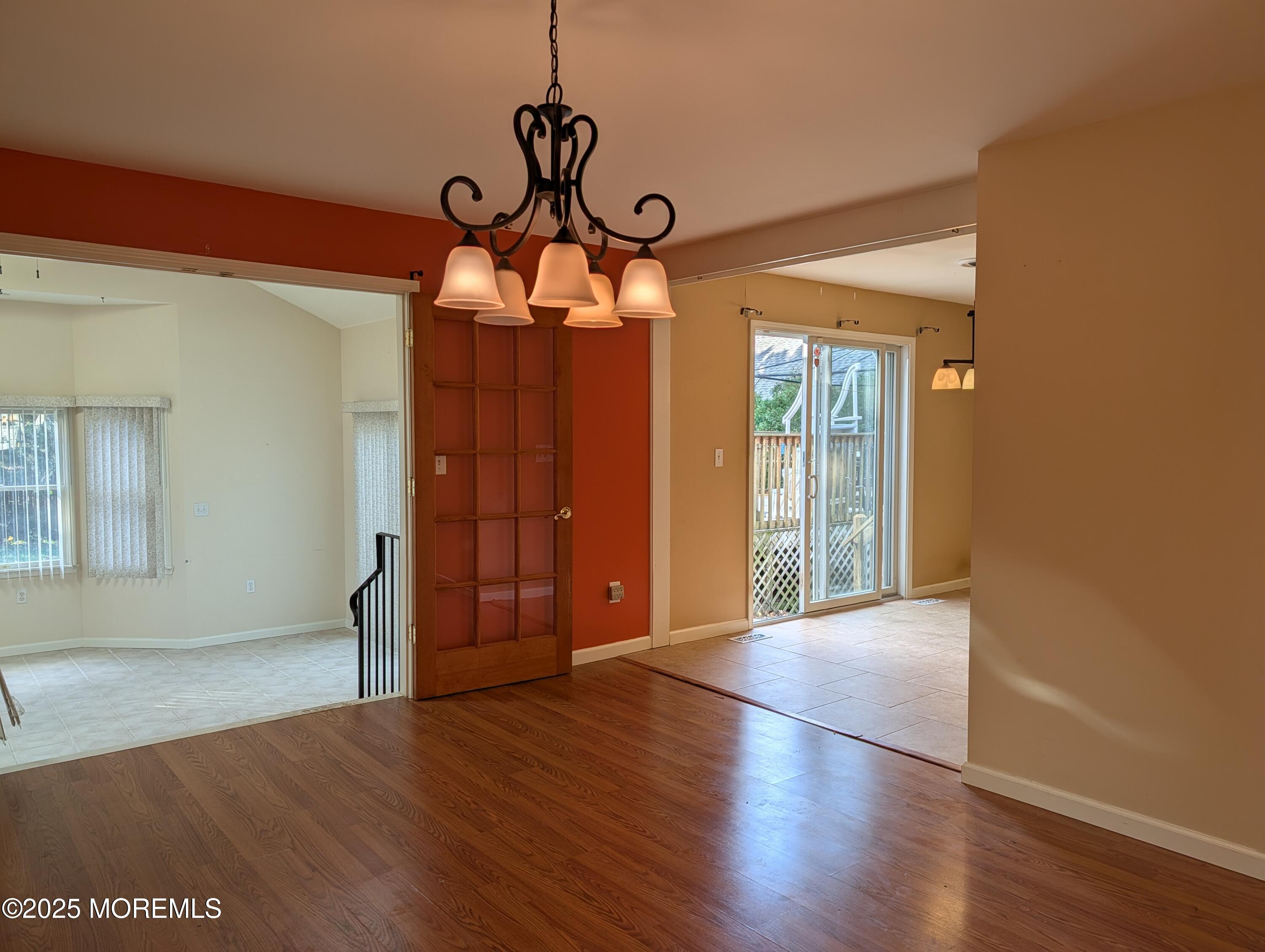 318 Eleanor Road Forked River, NJ 08731 - Photo 9 of 13 a view of a room with wooden floor and chandelier
