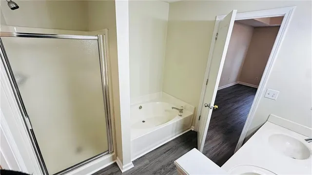 a bathroom with a bathtub and a shower