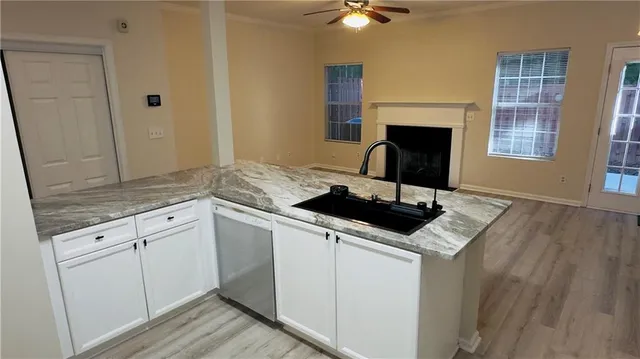 a kitchen with a sink cabinets and window