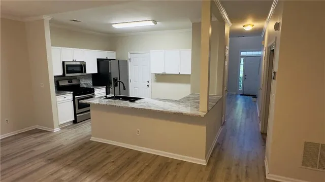 a view of a kitchen cabinets and wooden floor