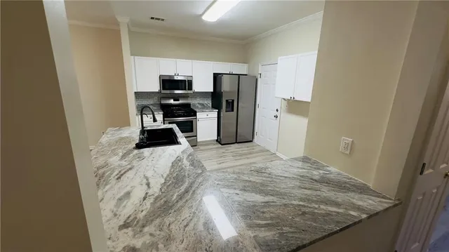 a kitchen with a refrigerator and a sink