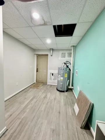 an entryway of a livingroom with wooden floor and a window