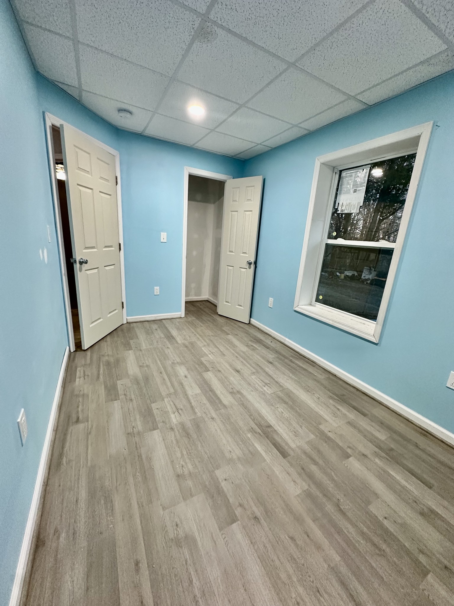 4036 Vernon Creek Road Cunningham, TN 37052 - Photo 18 of 26 a view of an empty room with wooden floor and a window