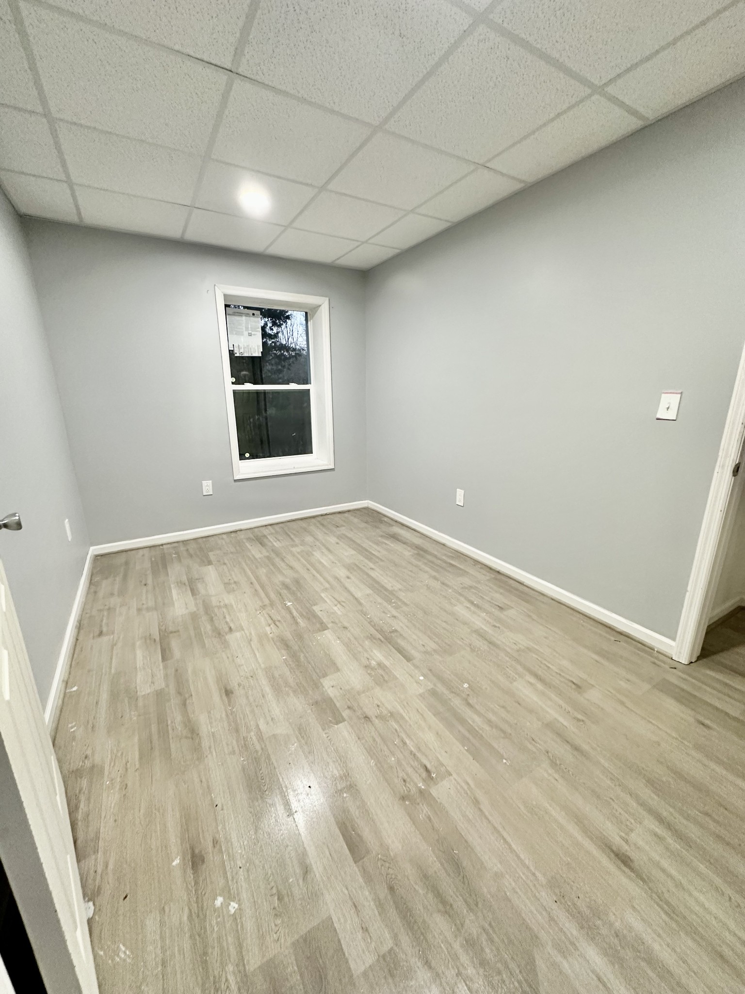 4036 Vernon Creek Road Cunningham, TN 37052 - Photo 19 of 26 an empty room with wooden floor and windows