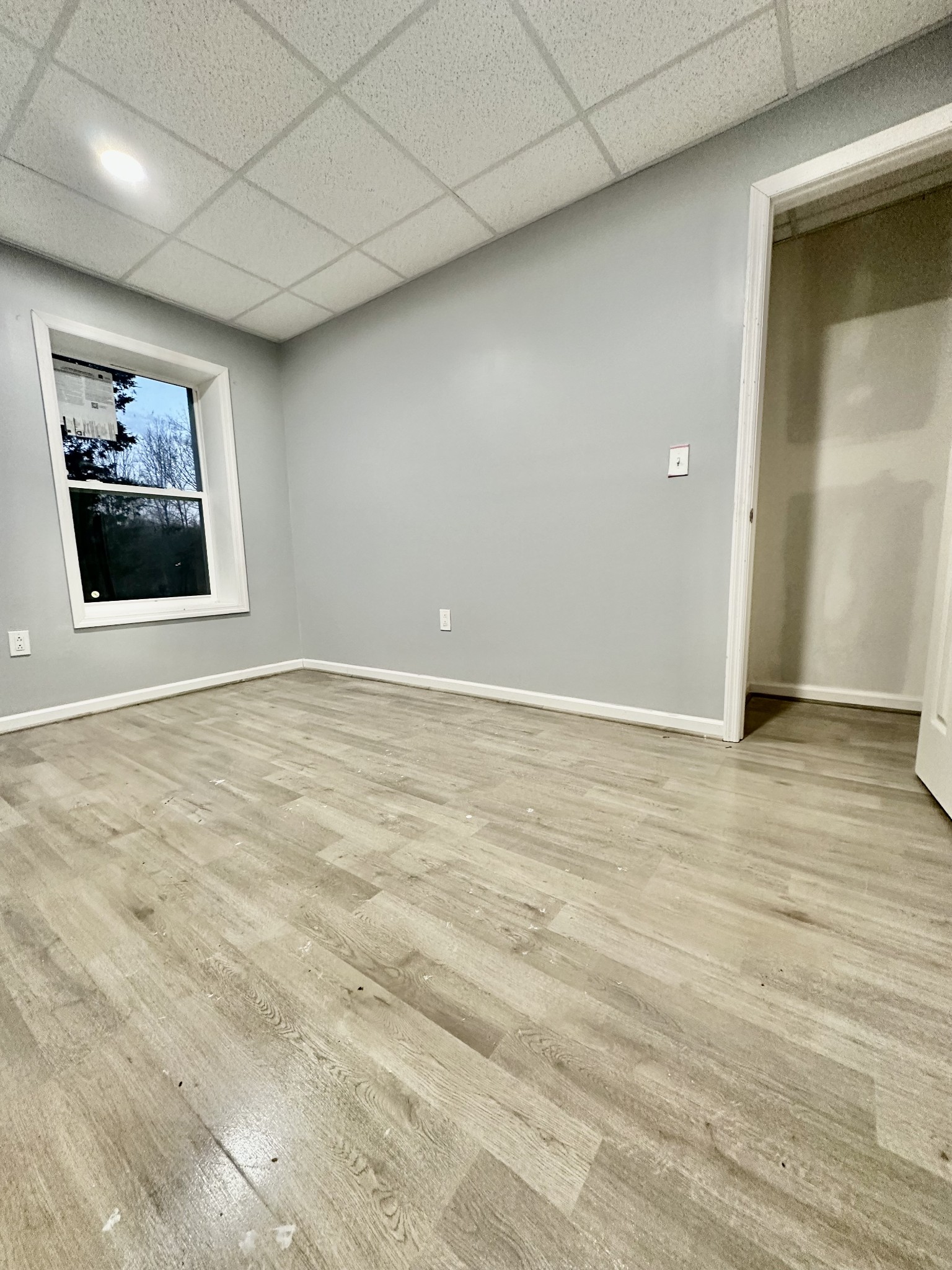4036 Vernon Creek Road Cunningham, TN 37052 - Photo 20 of 26 an empty room with wooden floor and windows