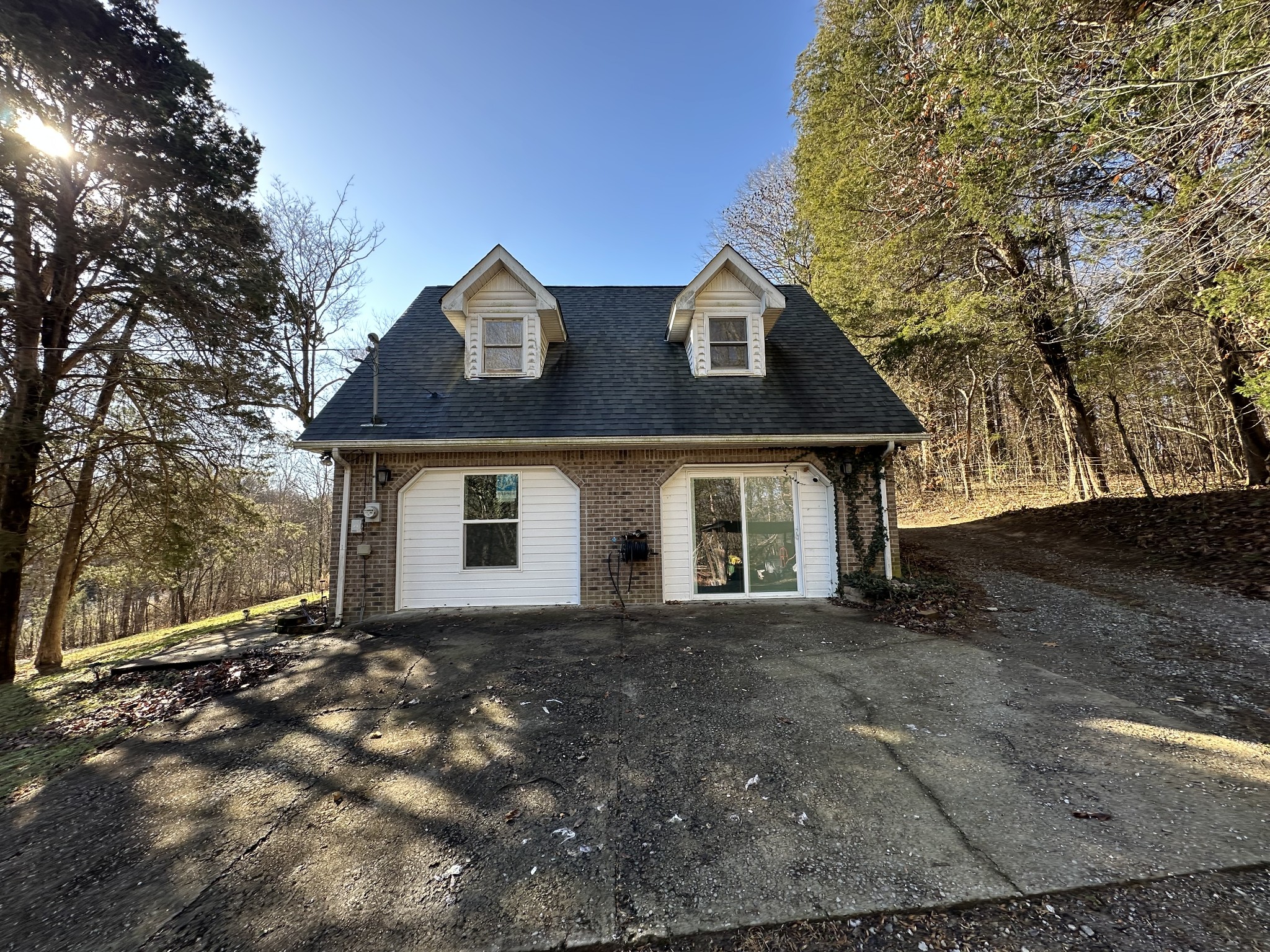 4036 Vernon Creek Road Cunningham, TN 37052 - Photo 3 of 26 a front view of a house with a yard and garage