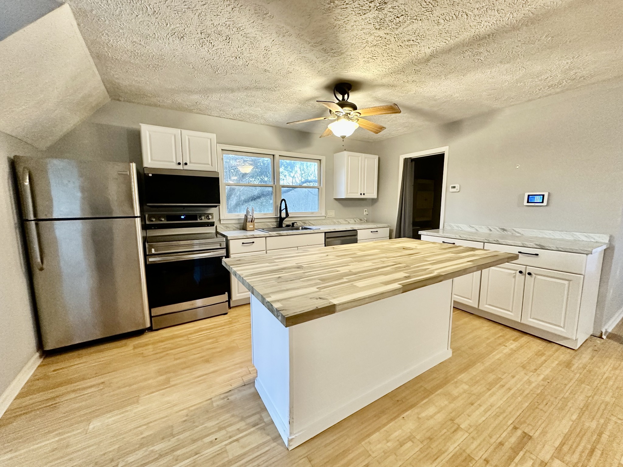 4036 Vernon Creek Road Cunningham, TN 37052 - Photo 5 of 26 a kitchen with kitchen island a sink appliances and cabinets