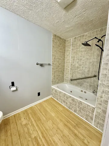 a bathroom with a sink toilet a mirror and shower