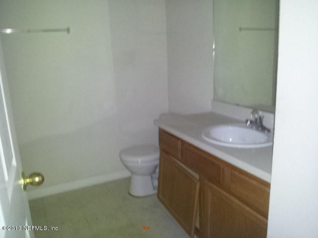 7920 Merrill Road, Unit 1701 Jacksonville, FL 32277 - Photo 3 of 8 a bathroom with a sink and a toilet