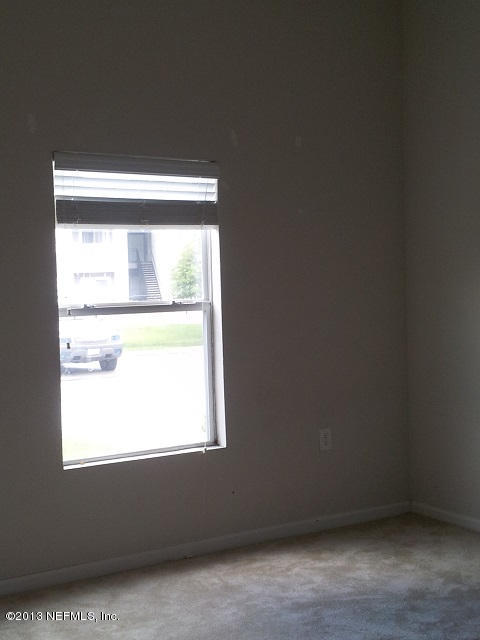 7920 Merrill Road, Unit 1701 Jacksonville, FL 32277 - Photo 5 of 8 a view of an empty room with a window
